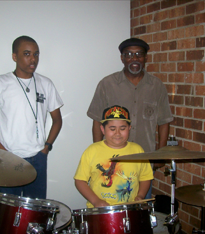 William "Rod" Garland, from the group Rebirth, and grandson, giving Jarred a few pointers on the drums!