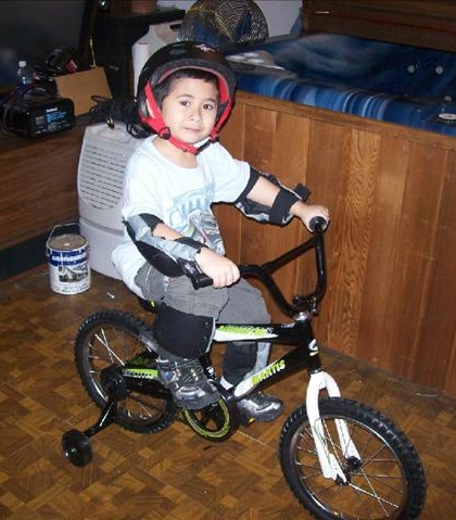 Christmas 2010! Jarred got his new bike and is all dressed up with no place to go! We got a white Christmas so I pulled the van outside so he would have somewhere to ride!