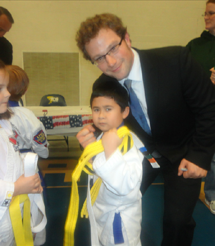 Jarred at Karate graduation, is presented with his Yellow Belt!