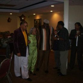 Abraham escorting Ms. Waters (in green) to the podium1 Abraham escorting Ms. Waters (in green) to the podium1