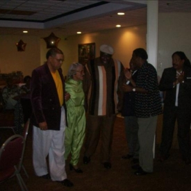 Abraham escorting Ms. Waters (in green) to the podium1 Abraham escorting Ms. Waters (in green) to the podium1